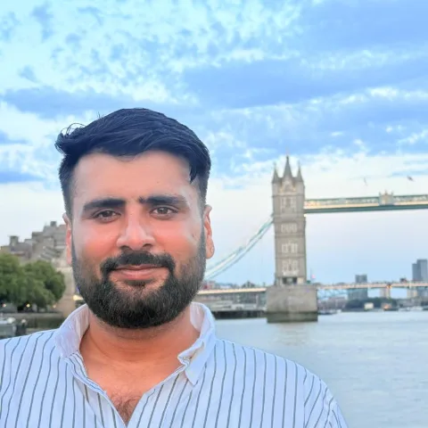 Mohit Malik, Head of Holidays at Adiona, by the Thames with Tower Bridge behind him