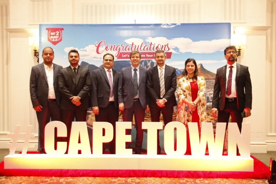 Guests in suits behind giant Cape Town letters at a congratulations backdrop