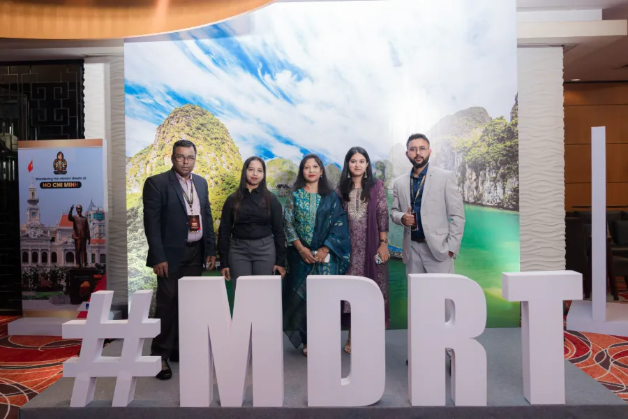 Guests posing behind large MDRT letters