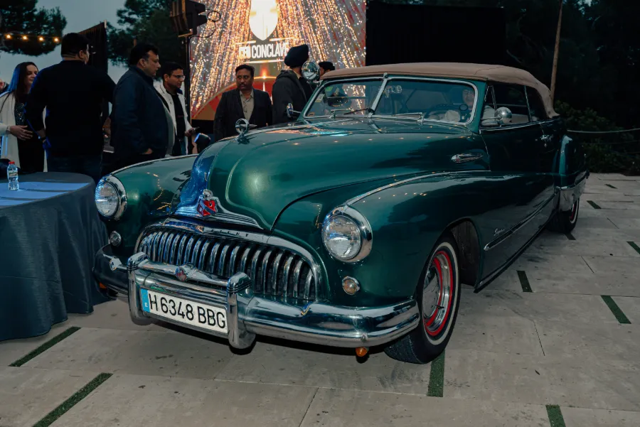A vintage car parked at the Niva Bupa CEO Conclave venue at night