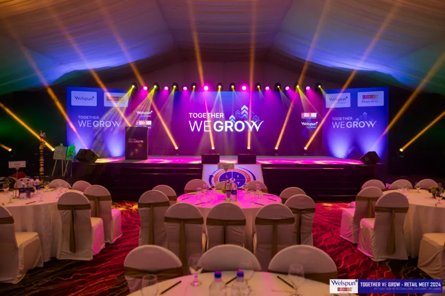 Stage and banquet tables at the Welspun We Grow conference